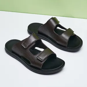 Detailed view of dark brown leather-textured men's summer slides with adjustable straps