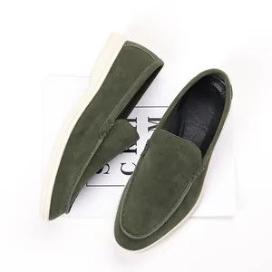Top view detail of dark green suede loafers for men on a minimalist background