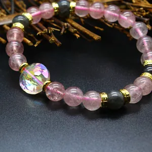 Macro view of natural strawberry quartz bracelet featuring an iridescent crystal bead