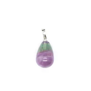 Macro view of a teardrop-shaped natural crystal pendant with green and purple bands