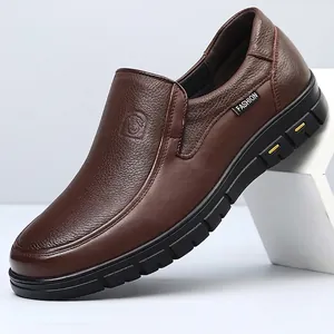 Close-up showing the textured brown leather and durable black sole of these loafers