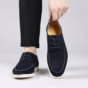 Detailed macro view of dark blue suede lace-up loafers with contrasting white soles