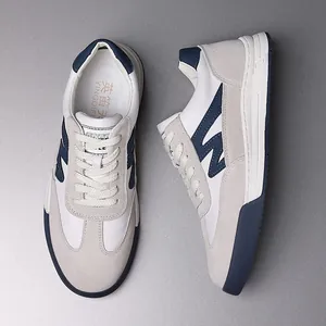 Detailed view of retro white and navy blue German trainer style sneakers for men