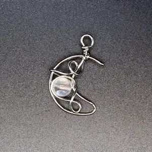 Detailed view of handmade silver wire wrapped crescent moon pendant with natural sunstone.