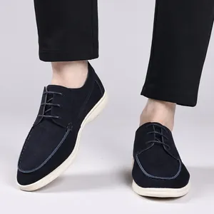 Detailed view of men's navy blue suede casual lace-up shoes with white soles