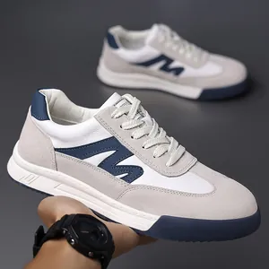 Detailed view of men's retro German Army Trainer sneakers in white and grey leather.