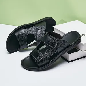 Detailed view of stylish men's non-slip black textured leather sandals on a stand