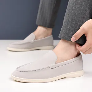 Detailed close-up of grey breathable suede loafers showing stitching and texture