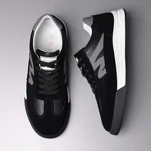 Detailed view of black retro German Army Trainers with suede and leather textures