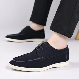 Close-up detail of men's navy blue suede lace-up leisure shoes with white rubber soles
