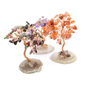 Detailed view of three handcrafted gemstone chakra trees with natural agate slice bases