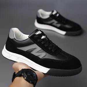 Detailed view of men's retro black leather casual sneakers with thick sole and M logo