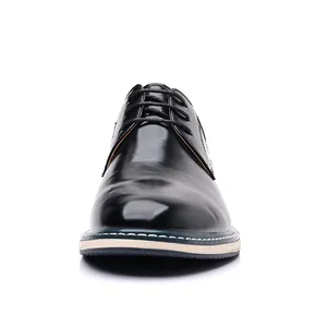 Front view detail of shiny black men's leather dress shoes with lace-up design