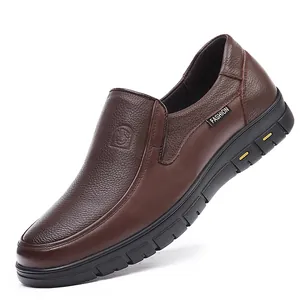 Detail of brown genuine leather men's slip-on loafer with textured finish and side label