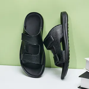 Close-up of black pebble-textured leather straps on men's non-slip fashion slides