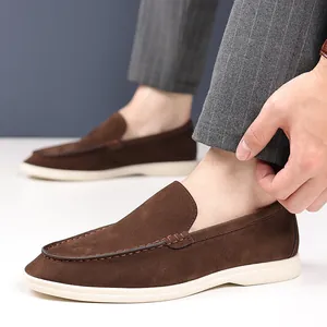 Close-up detail of stylish brown suede loafers for men showing fine stitching and soft texture