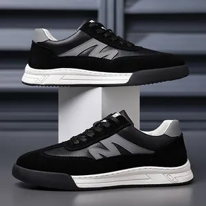 Close-up view of men's retro black sneakers featuring premium suede and leather textures