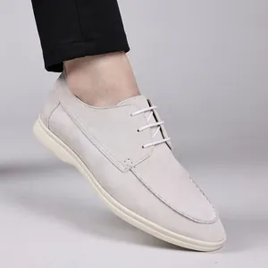 Detailed side view of light grey suede casual shoes with white laces and soles