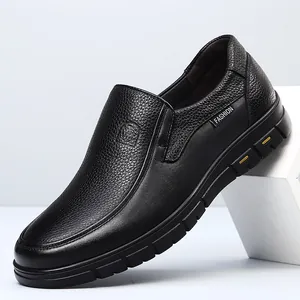 High-quality detail view of black genuine leather men's slip-on loafers with textured finish