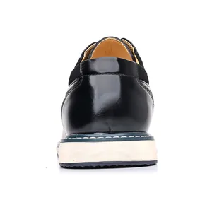 Detailed rear view of a black leather work shoe featuring a white sole and blue stitching