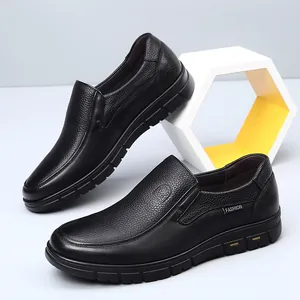 Detail view of black genuine leather men's casual slip-on shoes with pebbled texture.