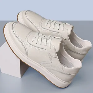 Detail of white pebbled leather men's casual sneakers with anti-slip brown sole