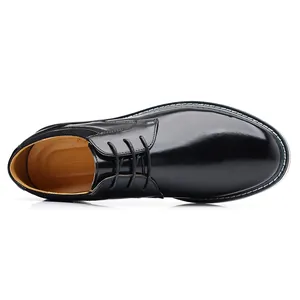 Top view of classic black leather lace-up dress shoes with white contrast stitching