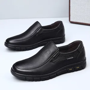 Close-up of black genuine leather loafers with textured finish and slip-on design.