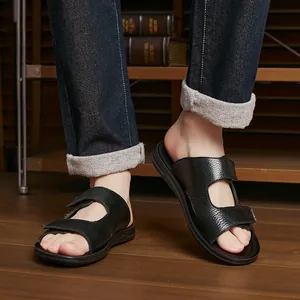 Stylish men's black pebbled leather slides for summer outdoor and home use shown on feet