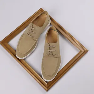 Detail view of stylish men's khaki suede loafers with laces and white flat soles