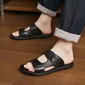 Macro view of black textured leather men's slippers worn by model on wooden floor
