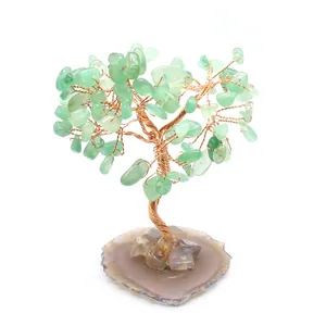 Close-up detail of a handmade green aventurine crystal tree with agate slice base
