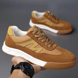 Detailed view of vintage brown suede leather men's GAT sneakers being held in hand