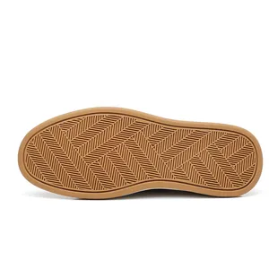 Close-up of brown rubber outsole with herringbone anti-slip pattern for men's shoes