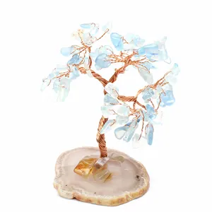 Handmade wire wrapped crystal tree with light blue stones on natural agate base