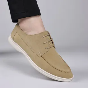 Detailed side view of beige suede casual shoes with white sole and thin round laces