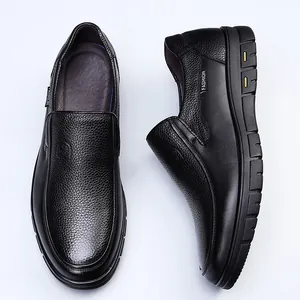 Close-up of black cowhide leather loafers showing fine texture and stitching detail