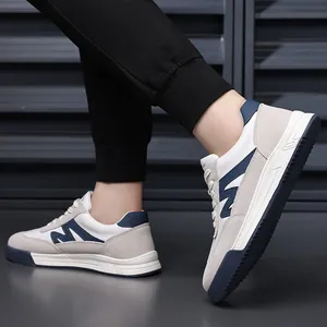 Side view of retro men's German army trainer shoes in a stylish navy and white color