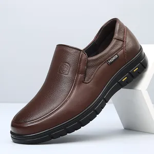 Detailed side view of brown leather loafer showing grain texture and slip-on design