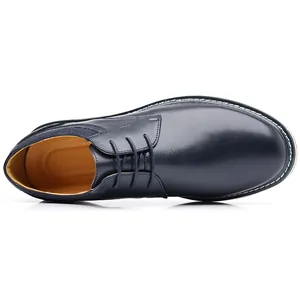Top view of classic navy blue leather men's dress shoe with white welt stitching