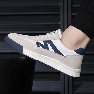 Detail view of men's retro leather sneakers with thick soles and navy M logo.