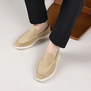 Close-up view of beige suede loafers for men, stylish slip-on driving shoes