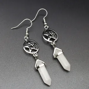 Detailed view of silver hollow pentagram earrings with white opal hexagonal stone pillars