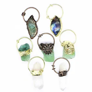 Detailed view of assorted raw crystal pendants with labradorite and sun flower metal accents