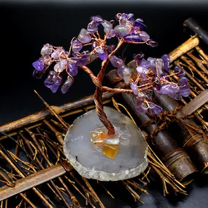 Detail of amethyst crystal wire wrapped tree with natural agate slice base
