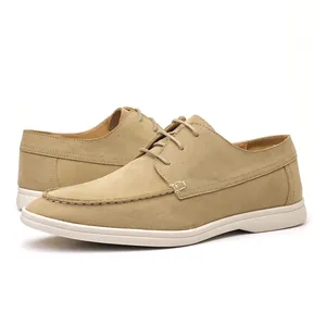 Close-up view of khaki suede casual men's lace-up shoes with white flat soles