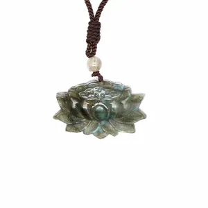 Detail macro view of hand-carved lotus-shaped labradorite pendant showing natural blue flash