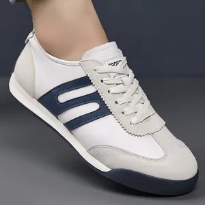 Side view of white and navy men's GAT sneakers with suede and leather textures