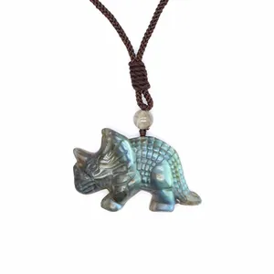 Detailed view of hand-carved Labradorite triceratops dinosaur pendant