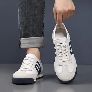 Detailed view of stylish men's retro German Army Trainer sneakers in white and grey